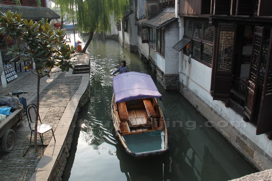 A boat lady is slowly row the boat