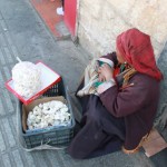 A local cake vendor sitting the street of Beijing Road.