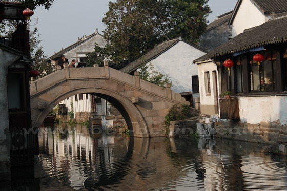 A pretty stone archway bridge spans the canal.