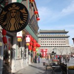 By the decorated archway is a starbucks with old design