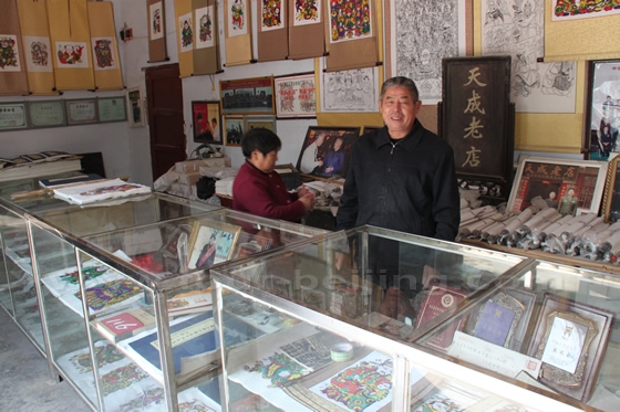 Mr Yin Guoquan  smiling behind his counter
