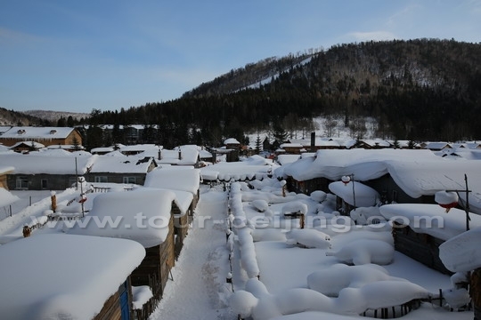 Rows of houses and courtyards are blanketed by white snow