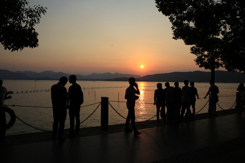 A Silhouette photo of the sunset over West Lake