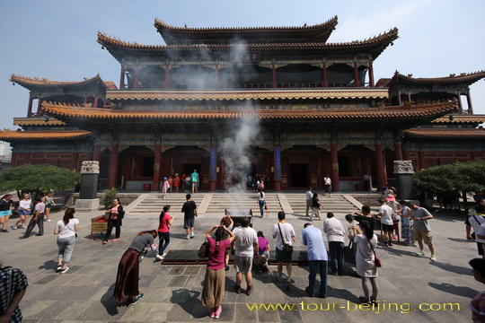 Burning and Praying before the Hall of Harmony and Peace , the main building of Lama Temple