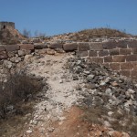 The bricks in the wall are in pieces