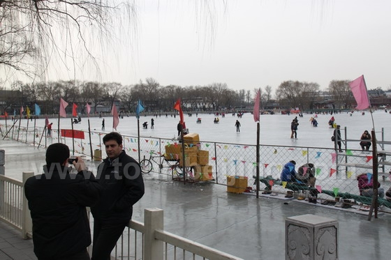 The icy cold has failed to stop the two foreigners enjoying the ice fun.