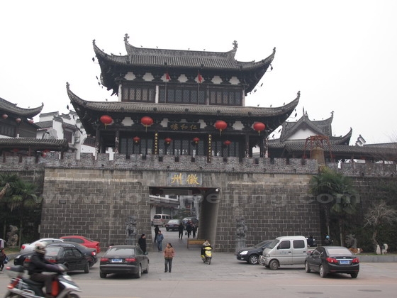 The massive stone gate is topped with a two-tier pavilion
