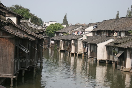 The old wood houses built by the water pathway.