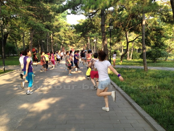The sacred way between the Heavenly West Gate to the west gates of the Sun Altar is filled with people who are seeking Happiness through exercising.