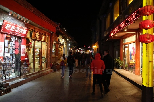 The stone and slab paved street is flanked with shops and boutiques. 