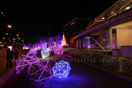 The streetfront garden was decorated with various forms of lights in front of China World Hotel. 