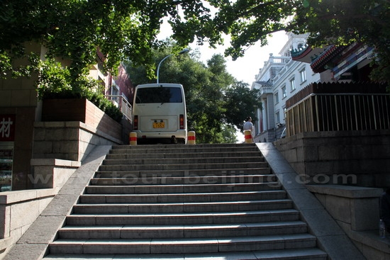 Walking up the steps leading to the east entrance to Dong Jiao Min Xiang