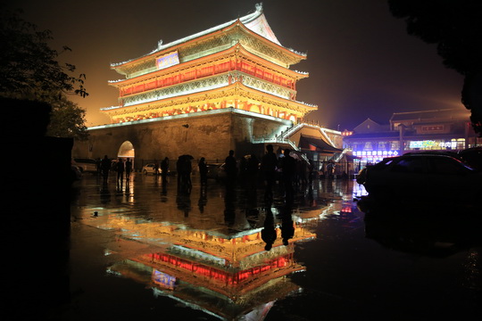 The illuminated Xian Drum Tower in the rain
