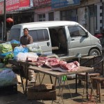 Pork and vegetable on the market by the street.