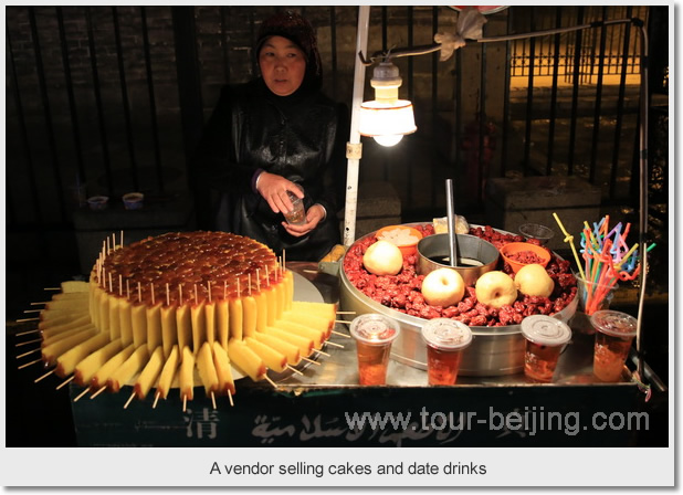 A vendor selling cakes and date drinks