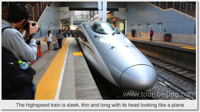 The highspeed train is sleek, thin and long with its head looking like a plane.