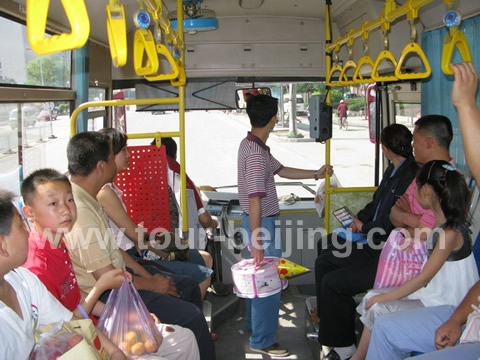 Get on the bus from its front door where the conductoress sells tickets and get off the middle door