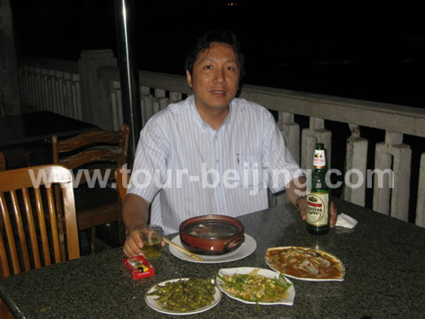 Enjoy the local food at a nice riverside restaurant opposite Yunshan Hotel by Wulie River