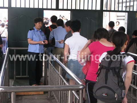 People moving through the ticket checking gate