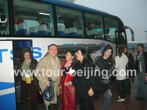 People were reluctant to leave Beijing and took the photo with Eva - our tour guide in red leather.