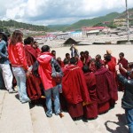 A group of monks debating in front of the main temple in the monastery.