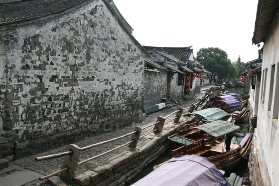 Boats are docking on the narrow canal