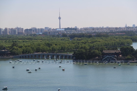 Boats are dotted on the Kunming Lake against the backdrop of the CCTV Tower.