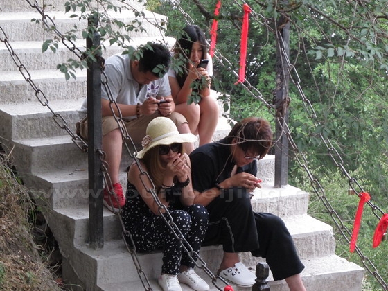 People on their mobiles to broadcast their actvities.