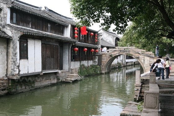 Rows of traditional houses stand by the rivers and bridges far away from the 