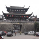 The massive stone gate is topped with a two-tier pavilion