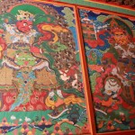 The tangka paitings on the wall by the entrance to the temple.