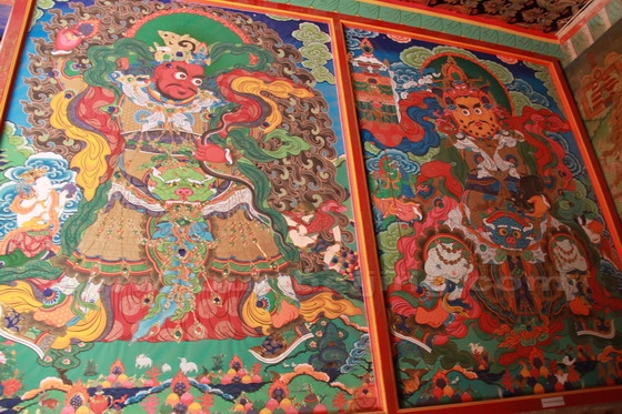 The tangka paitings on the wall by the entrance to the temple.