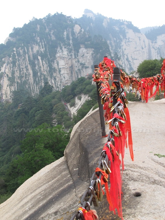 housands of love locks, colourfully festooned with flowing red ribbons.
