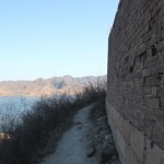 We tredge up the hill and walk along a trodden path by the wall.
