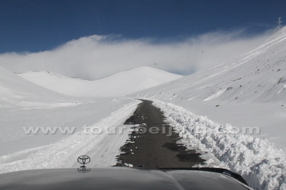 n the road sandwiched by the snow-capped peaks