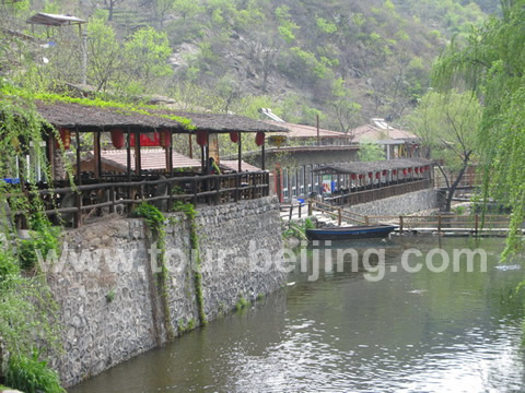 The stream lying in front of the main building, log cabin and restaurants on the terraces