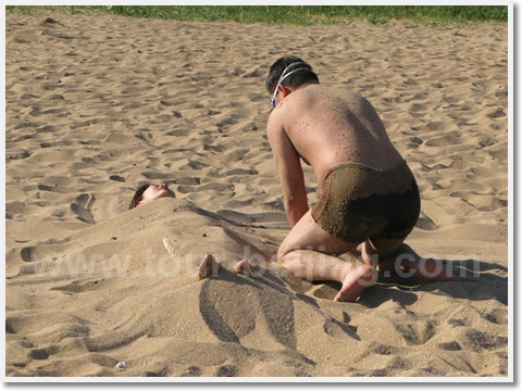 People are playing the sand on the beach.