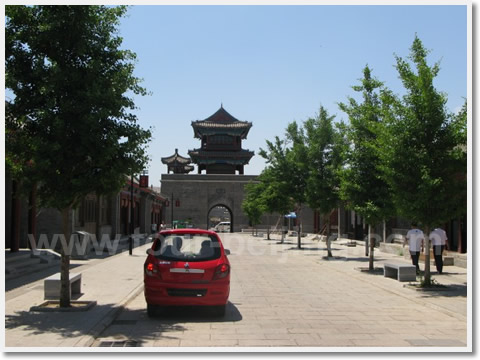 In the middle of the pass ctiy stands a tall bell tower.