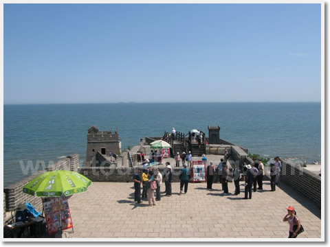 People are walking towards the head of the dragon - the easternmost end of the Great Wall.